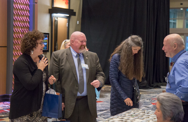 Tulalip Tribes’ 2018 Raising Hands photo of event with a guest getting a credential at the check-in table.