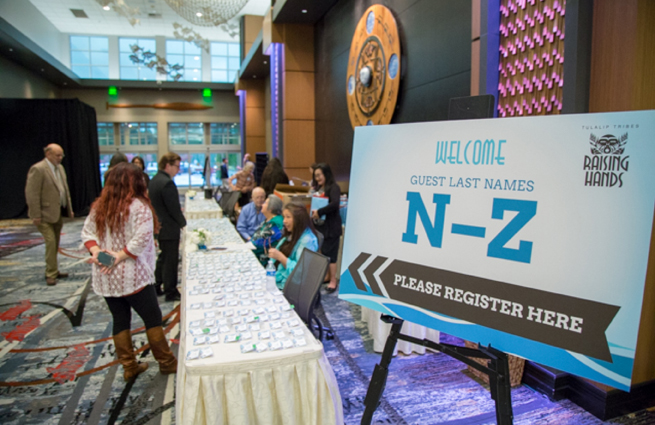 Tulalip Tribes’ 2018 Raising Hands photo of event with two guests at the check-in table.