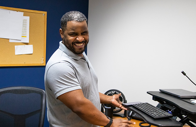 A blind man operating a computer and giving a presentation. 