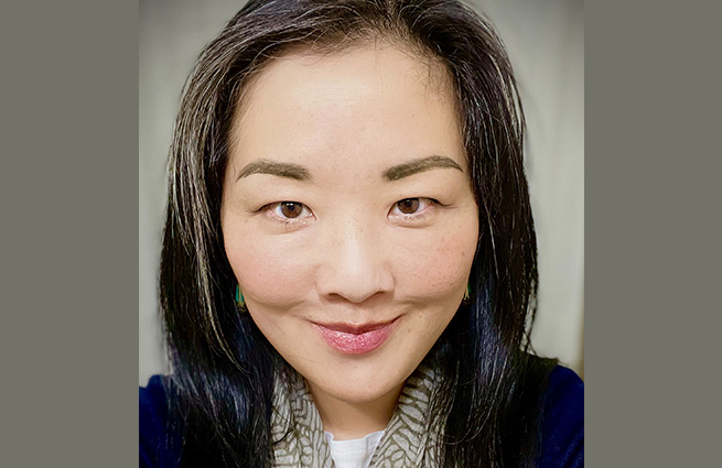 Portrait shoot of a young woman, smiling up close to the camera. 