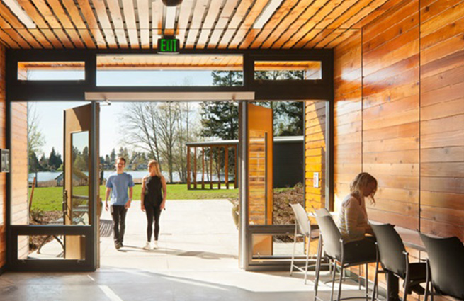 Entryway of the Navos building from just inside with two young boys entering the open doors. 