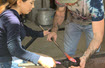 Students learning techniques of metal art, using furnaces under the supervision of adults. 